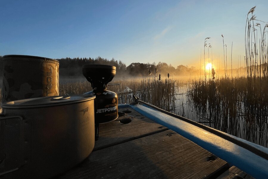 Vařič Jetboil a nádobí Keith u vody v Estonsku při východu slunce. Zdroj: Rigad