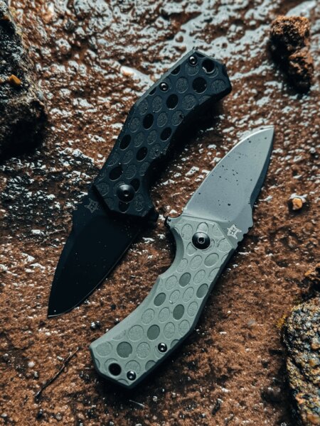 Dvojice zavíracích nožů Fox Knives® s černou a zelenou střenkou v outdoorovém prostředí. Foto: Rigad